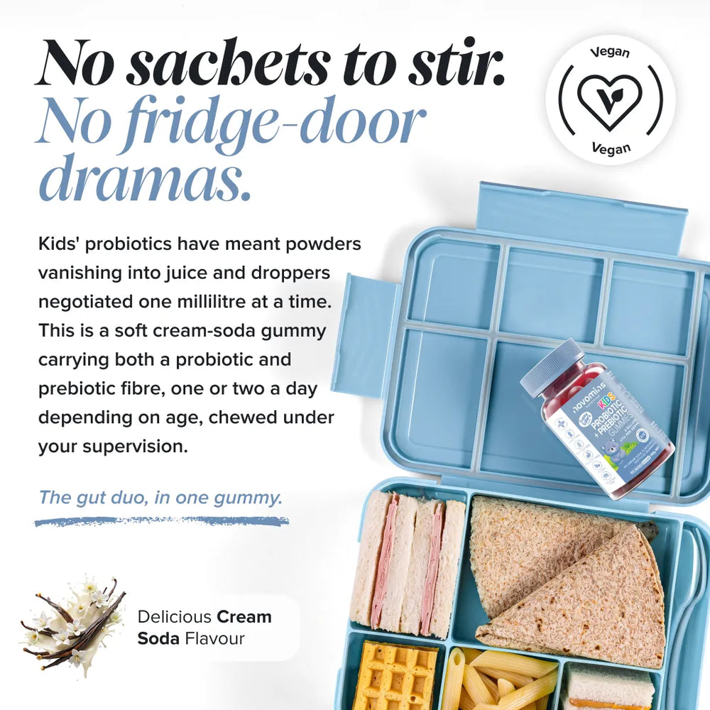 A promotional product graphic for a kids' lunch box with a small supplement bottle. The image shows an open light blue compartment lunch box filled with sandwich, waffles, pasta, and fruit, alongside the same box closed with the bottle resting inside.